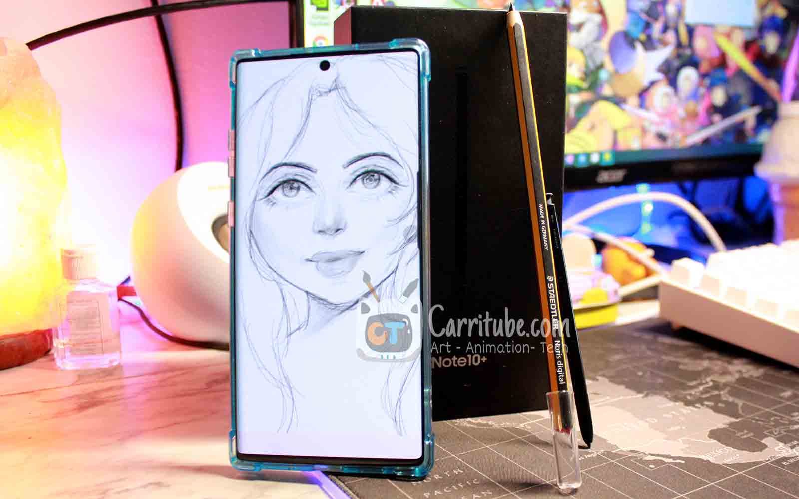note 10 with drawing standing up infront of its factory box
